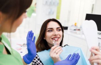 Dentist and a woman choosing dental veneers.