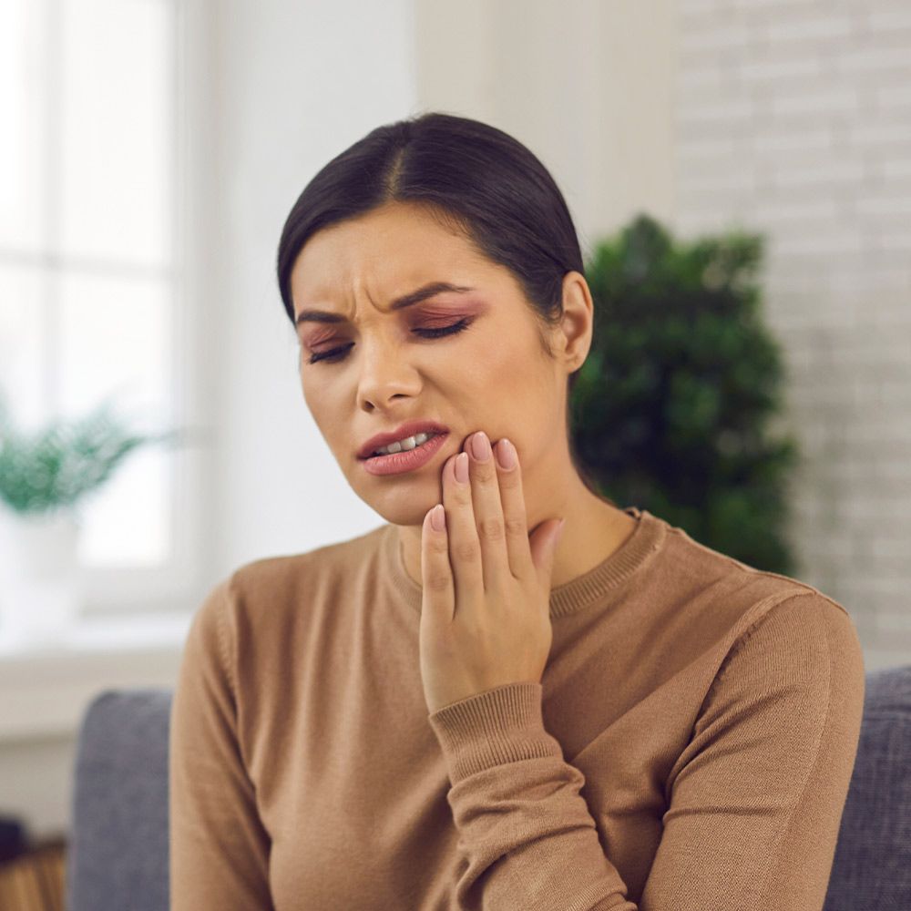 a young woman suffering from toothache